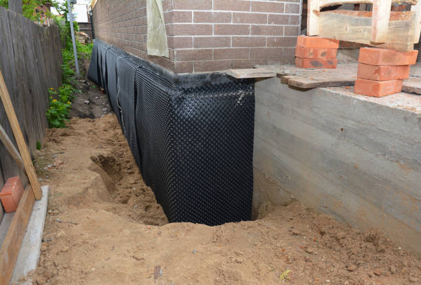 SJ Waterproofing Pros technician performing targeted Basement Waterproofing assessment in Norwich, KS